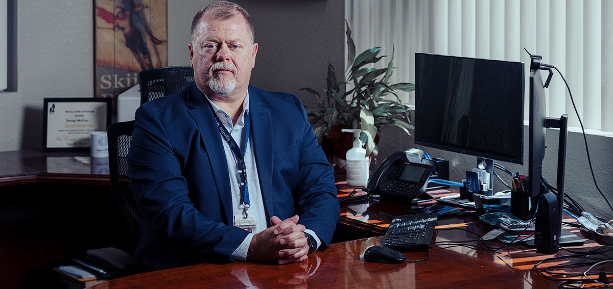 Eastern Plumas Health Care CEO Doug McCoy sitting at a desk