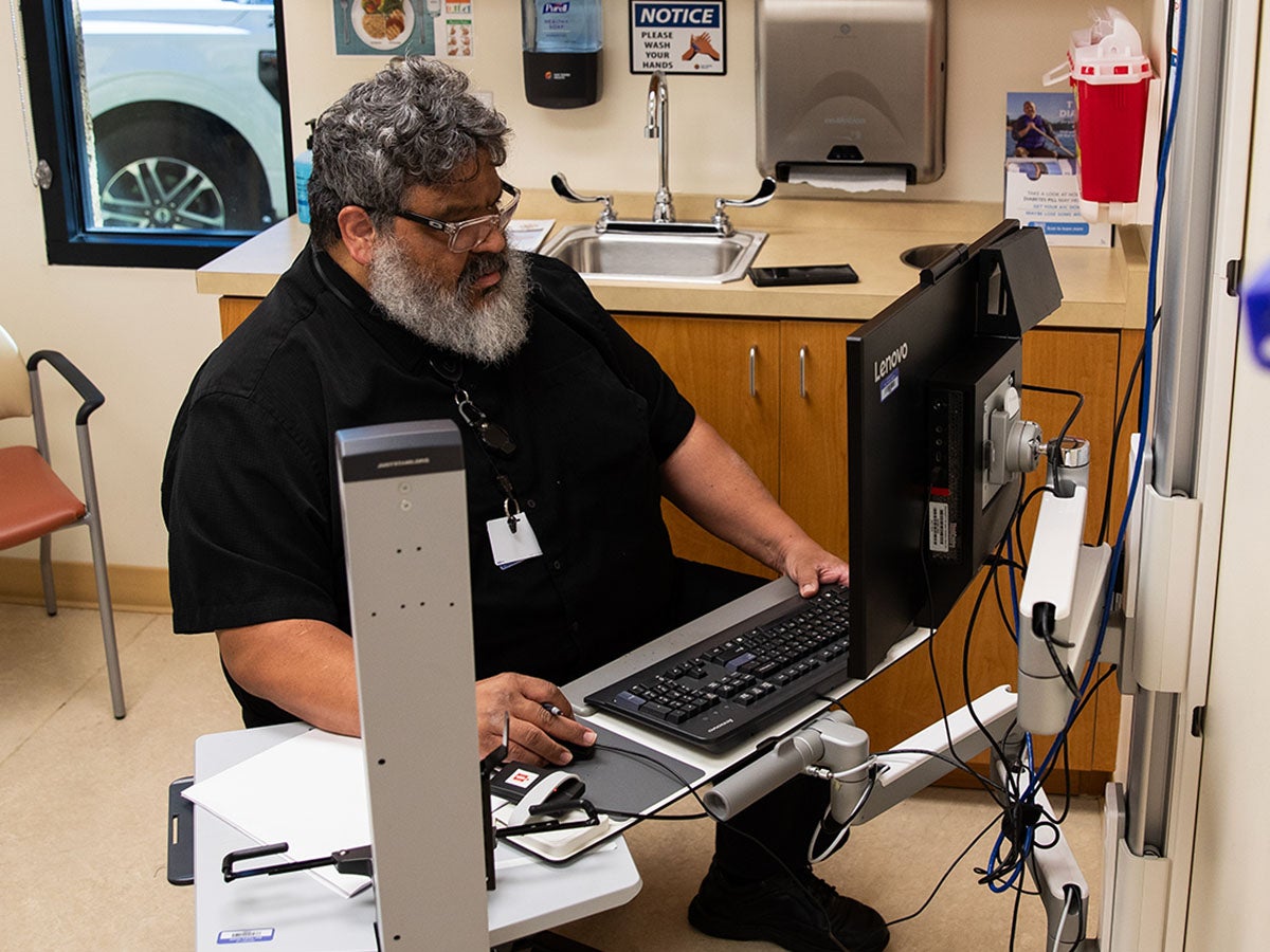 Dr. Francisco Tejeda prepares for a telehealth appointment with a patient
