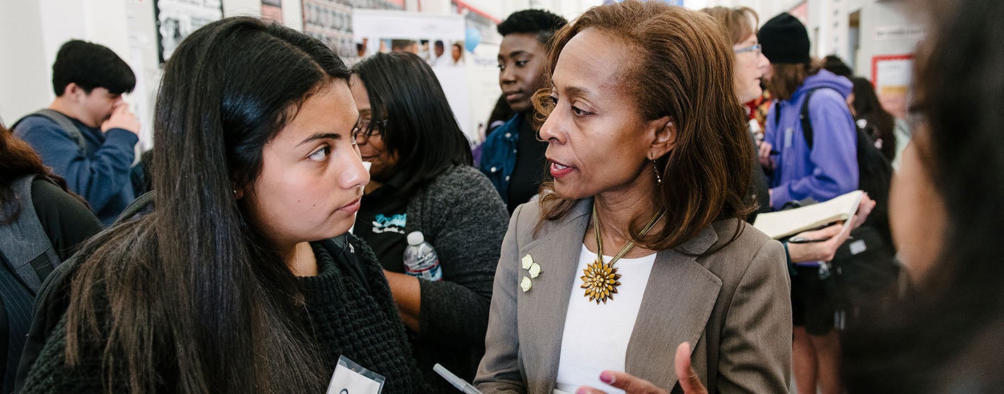 Dr. Freeman Garrick talks to high school student about future medical career