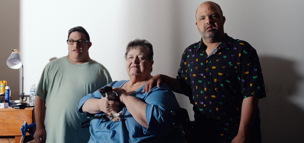 Elaine Berg lives in Bakersfield with her son Alpha Omega "Poppy" Stewart, right, who has Down syndrome. Both are Medi-Cal enrollees. Stewart's friend since high school, Daniel Montes, is at left.