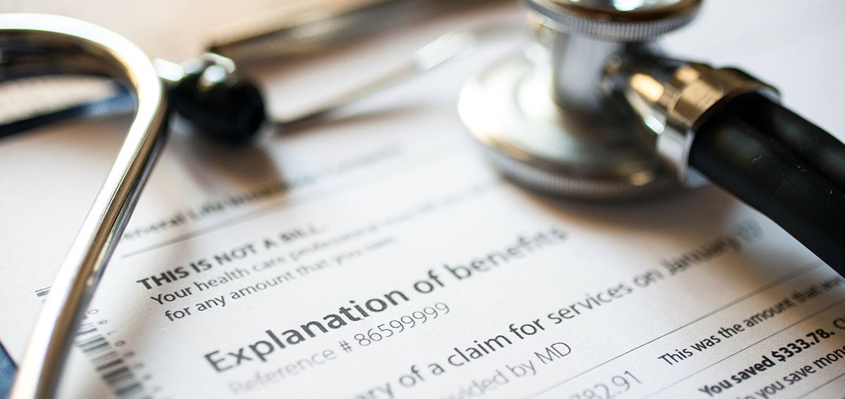 Stethoscope laying on top of document that reads "Explanation of benefits"