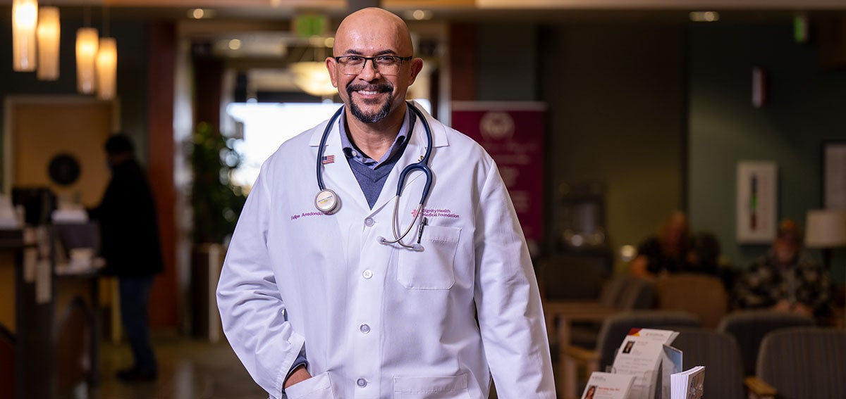 increasing racial-ethnic diversity of medical students. A physician in a white coat in the clinic where he practices.