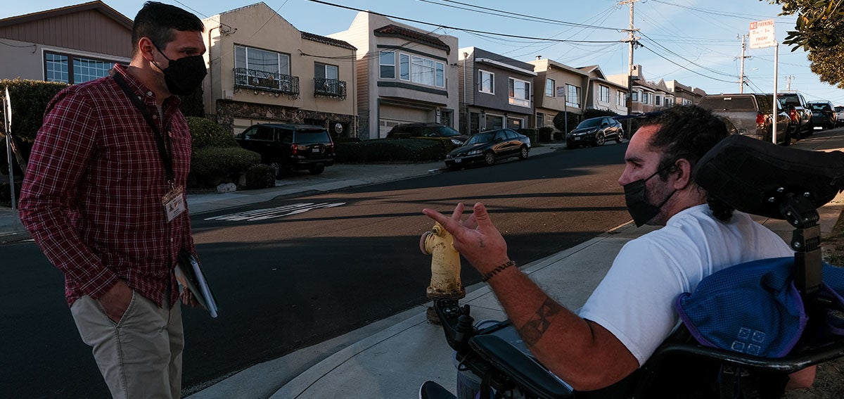 Case manager Jesse Aires, left, accompanies Ofisi Latu around the neighborhood of the Daly City care facility where he now lives.