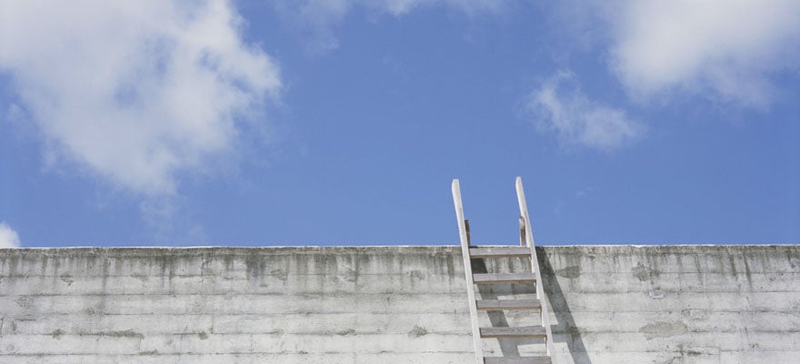 a ladder leaning against a wall, pointing towards a blue sky with fluffy white clouds