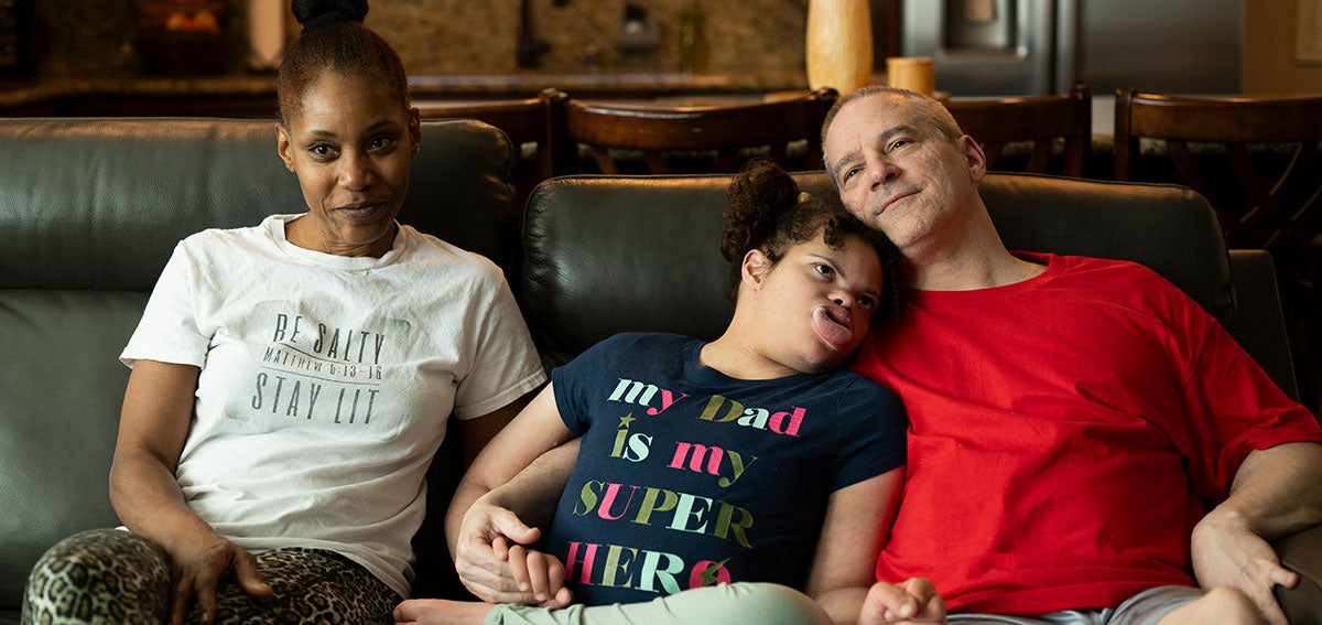 Orange County Protecting Medi-Cal - Mother, daughter, and father sitting on a couch